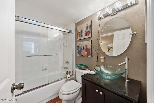 full bathroom with vanity, toilet, a textured ceiling, and shower / bath combination with glass door