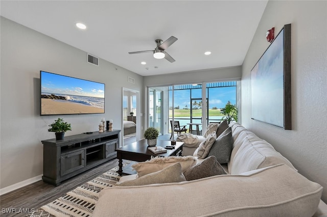 living room with ceiling fan and dark hardwood / wood-style floors