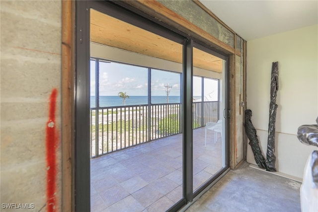 doorway to outside with a water view