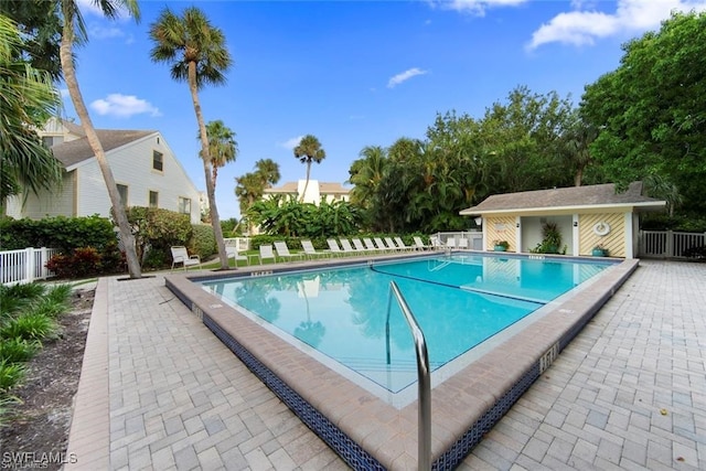 view of swimming pool featuring a patio area and an outbuilding