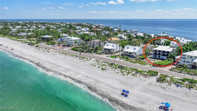 drone / aerial view featuring a water view and a view of the beach