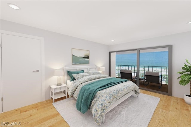 bedroom with a water view and wood-type flooring