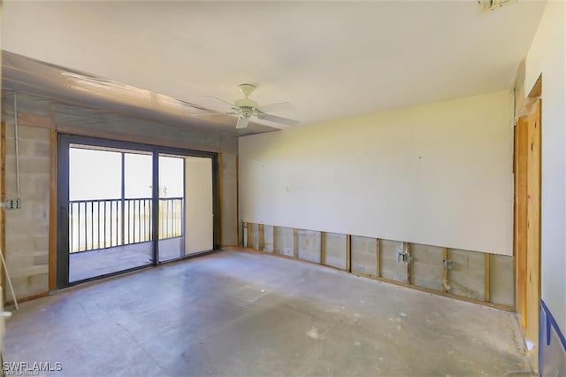 spare room with ceiling fan and concrete floors