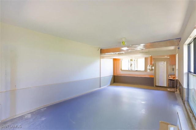 unfurnished room featuring concrete flooring and plenty of natural light