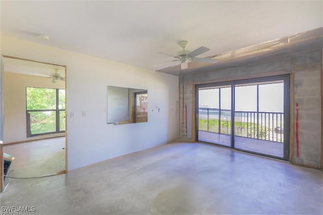 spare room with concrete floors and ceiling fan