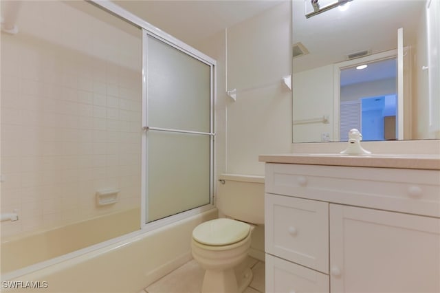 full bathroom featuring vanity, bath / shower combo with glass door, toilet, and tile patterned flooring