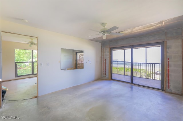 empty room with concrete flooring and ceiling fan