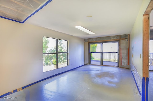 spare room with concrete floors and plenty of natural light