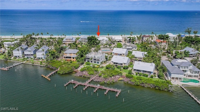 aerial view with a water view and a beach view