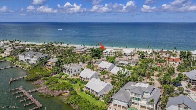 drone / aerial view with a water view and a beach view