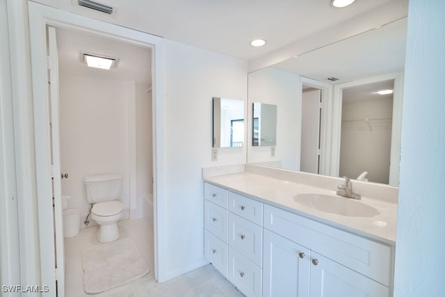 bathroom featuring tile patterned flooring, vanity, and toilet