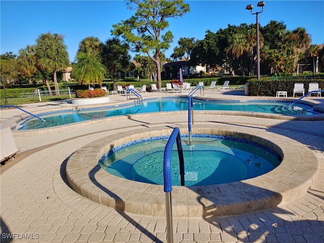 view of pool featuring a hot tub