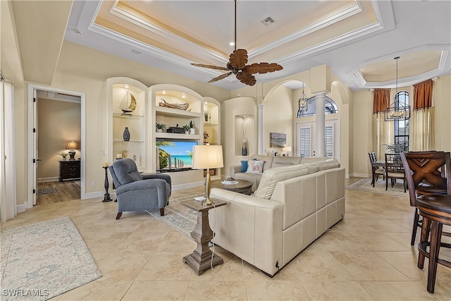 living room featuring ceiling fan, a raised ceiling, light tile patterned flooring, built in features, and crown molding