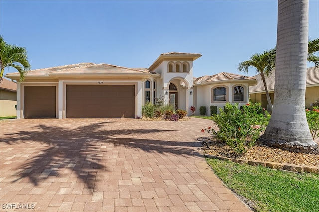 mediterranean / spanish-style house with a garage