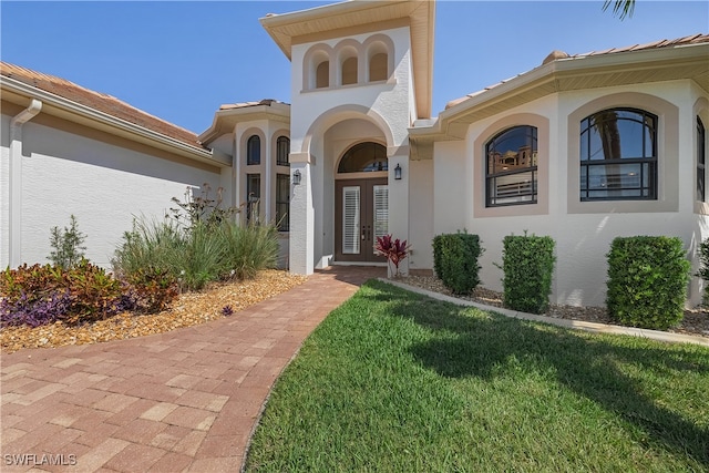 property entrance with a yard