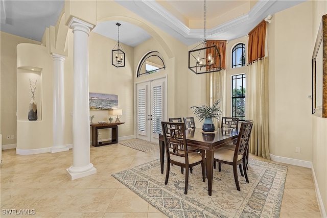 dining area featuring french doors, ornamental molding, a chandelier, and a high ceiling