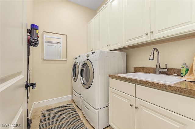 laundry room with light tile patterned floors, cabinets, sink, and separate washer and dryer