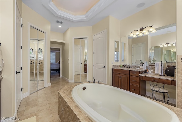 bathroom with vanity, crown molding, and a relaxing tiled tub