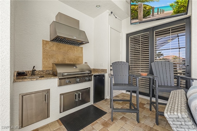 view of patio / terrace featuring area for grilling and sink