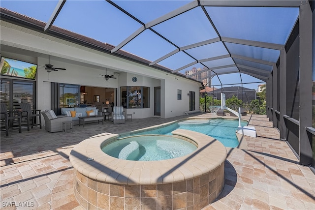 view of pool featuring an in ground hot tub, an outdoor hangout area, a patio area, glass enclosure, and ceiling fan