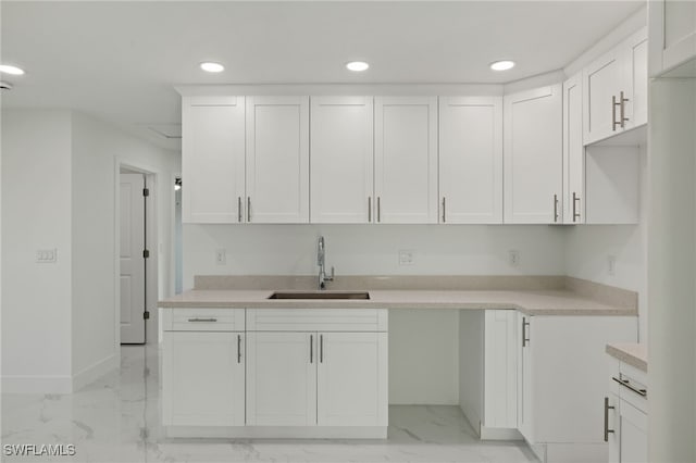 kitchen featuring white cabinets and sink