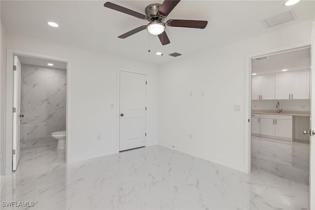 spare room with ceiling fan and sink