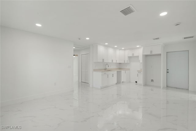 unfurnished living room featuring sink