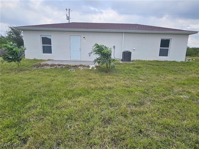 back of property featuring a yard and central AC unit