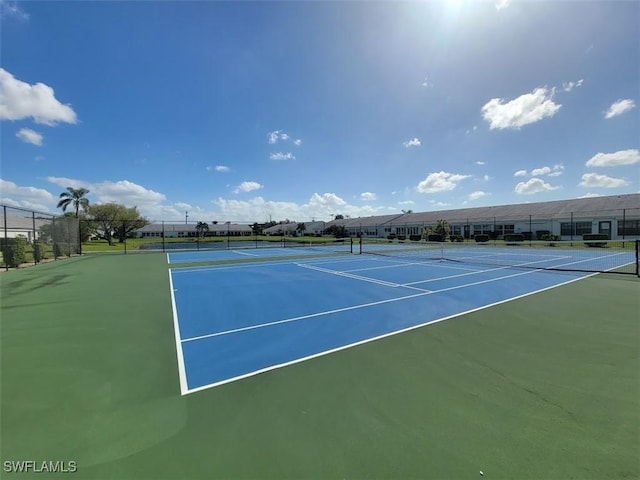 view of sport court featuring fence