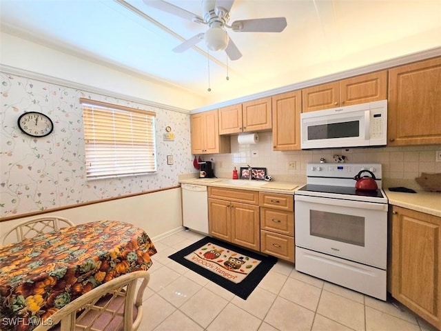 kitchen with light countertops, a ceiling fan, a sink, white appliances, and wallpapered walls