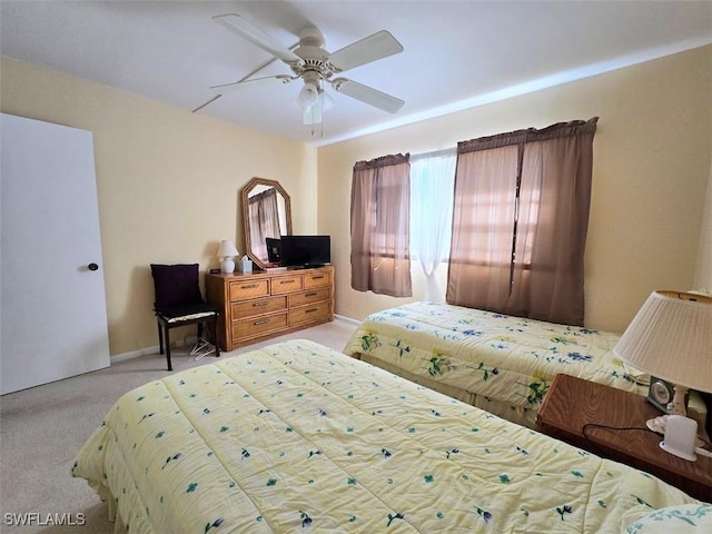 bedroom with a ceiling fan and light colored carpet