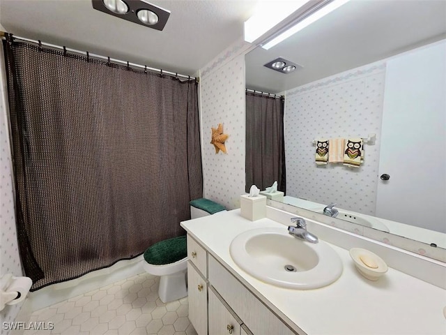 full bathroom featuring tile patterned floors, vanity, toilet, and wallpapered walls