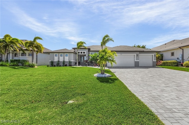 view of front of property with a front lawn and a garage