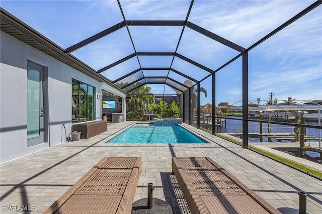 view of swimming pool featuring a water view, a patio area, a boat dock, and glass enclosure