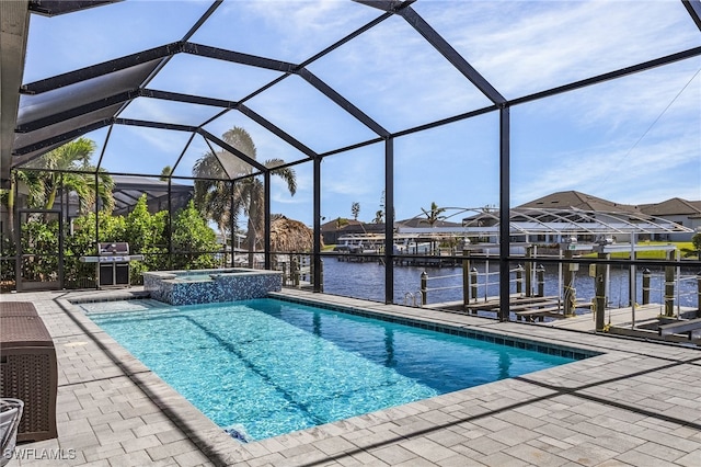 view of pool with a water view, an in ground hot tub, glass enclosure, and a patio area