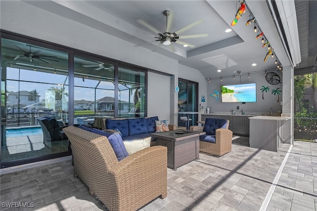 view of patio with an outdoor living space and ceiling fan