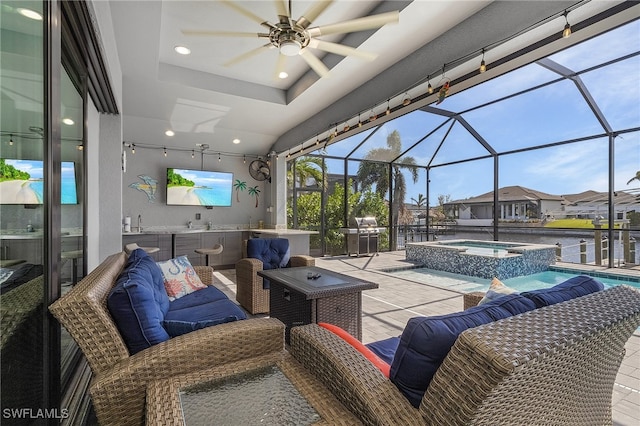 view of patio featuring a swimming pool with hot tub, glass enclosure, and ceiling fan