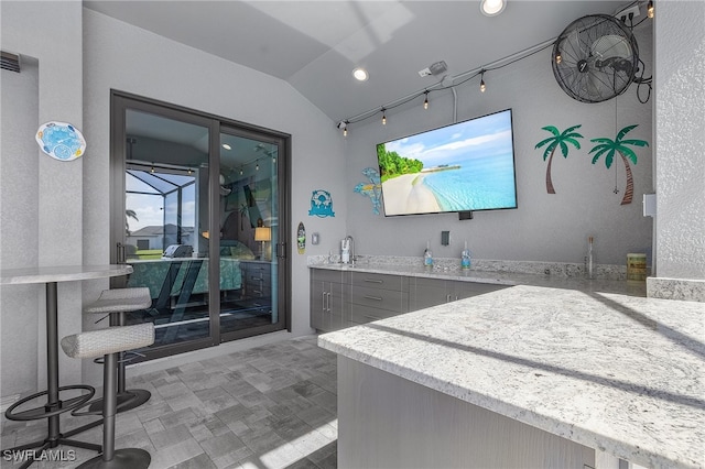 bathroom with lofted ceiling and sink