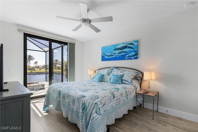 bedroom featuring a water view, ceiling fan, and light hardwood / wood-style floors