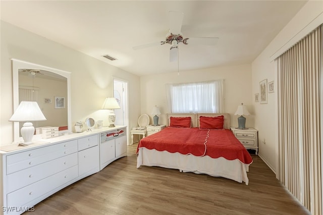 bedroom with ceiling fan and light hardwood / wood-style floors