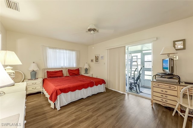 bedroom with access to outside, dark hardwood / wood-style floors, and ceiling fan