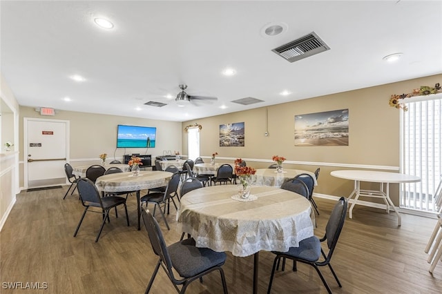 dining area featuring ceiling fan and dark wood-type flooring