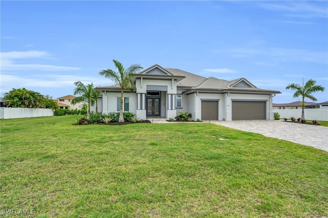 view of front of home featuring a front yard and a garage