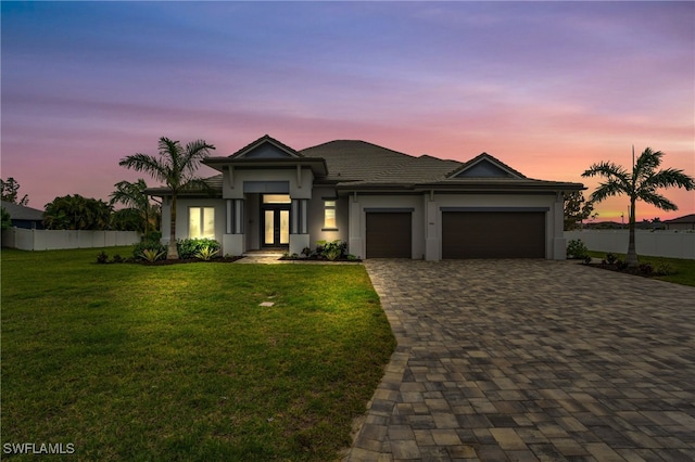 view of front facade featuring a lawn and a garage