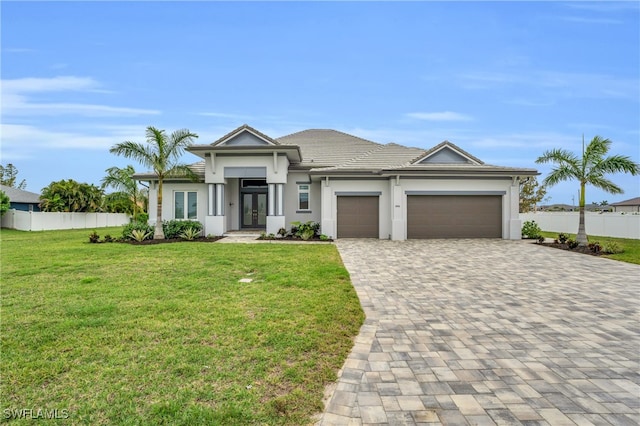 view of front facade featuring a front yard and a garage