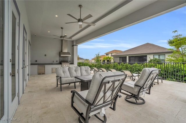 view of patio with area for grilling, sink, an outdoor hangout area, ceiling fan, and an outdoor kitchen