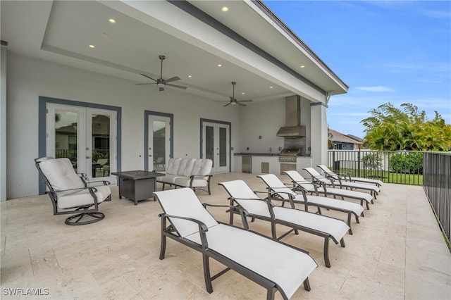 view of patio / terrace featuring french doors, ceiling fan, area for grilling, and an outdoor kitchen