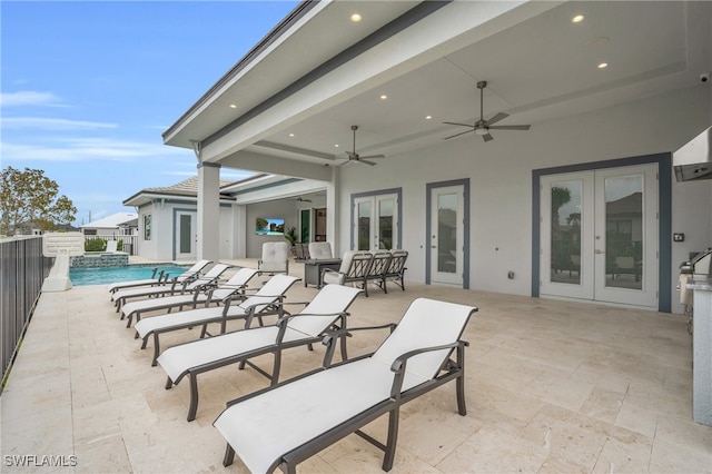 view of patio / terrace with french doors, a fenced in pool, and ceiling fan