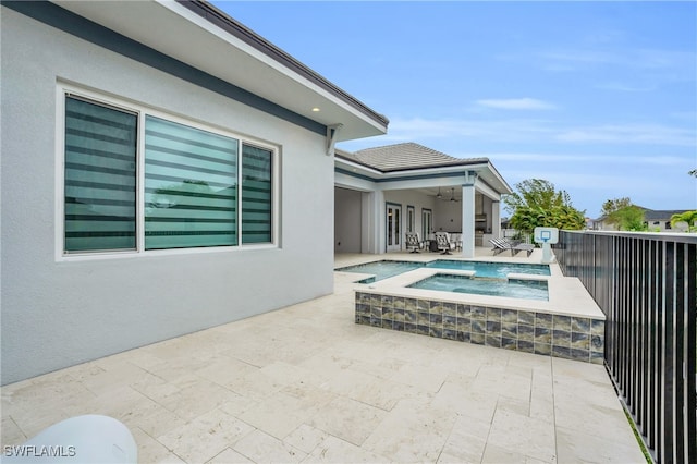 view of swimming pool featuring an in ground hot tub, a patio area, and ceiling fan