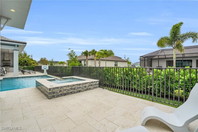 view of pool featuring an in ground hot tub, a patio, and glass enclosure